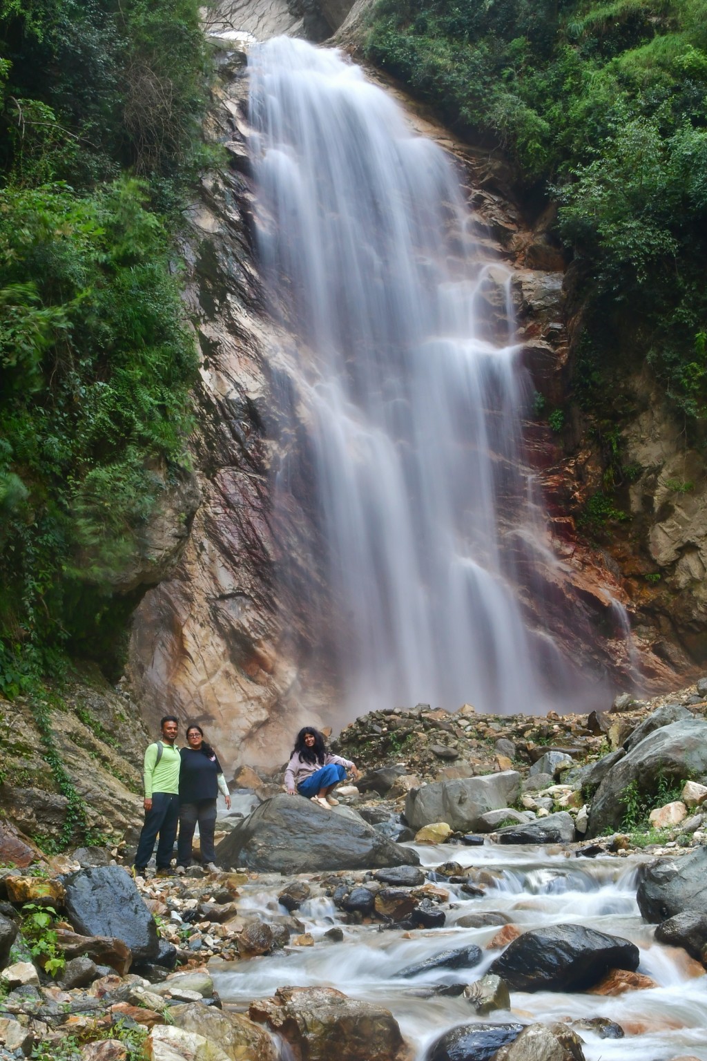 Himalayan waterfall surrounded by forest