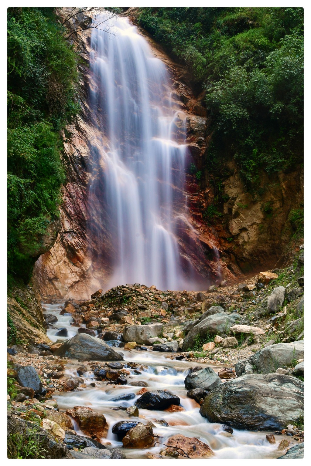 Waterfall in a green Himalayan valley